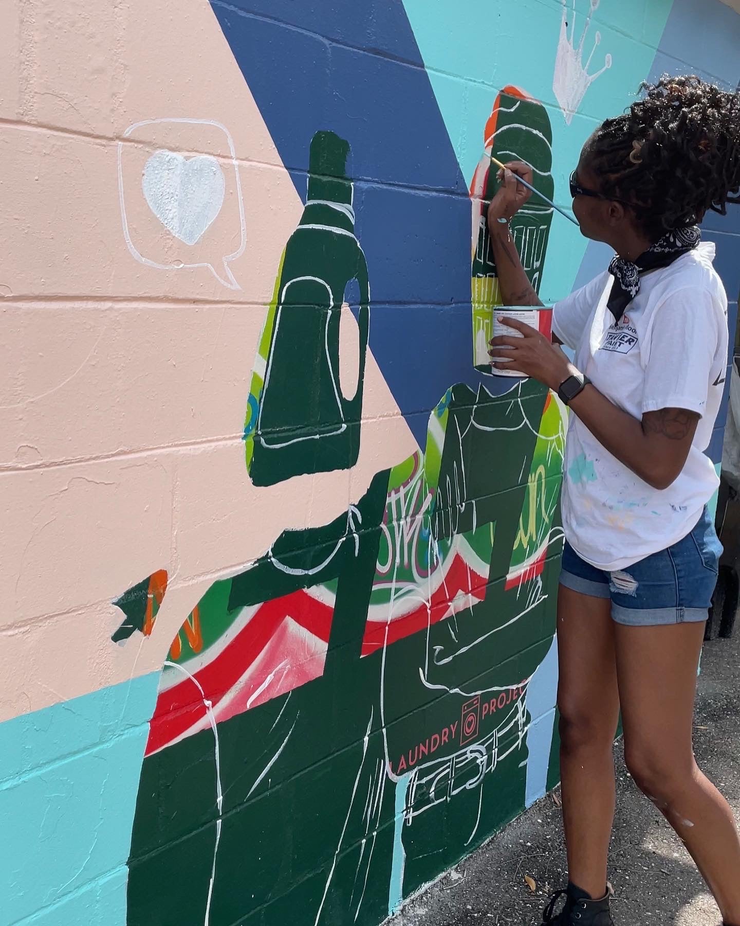 Quinn Cale Tampa based mural artist painting wall mural